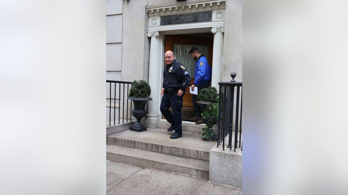 Police exiting Robert De Niro's NYC townhouse.