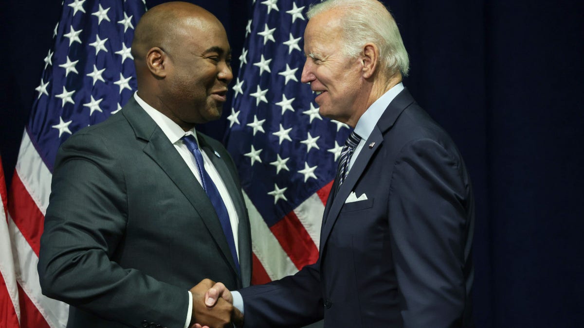 DNC Chairman Jaime Harrison shakes hands with President Joe Biden