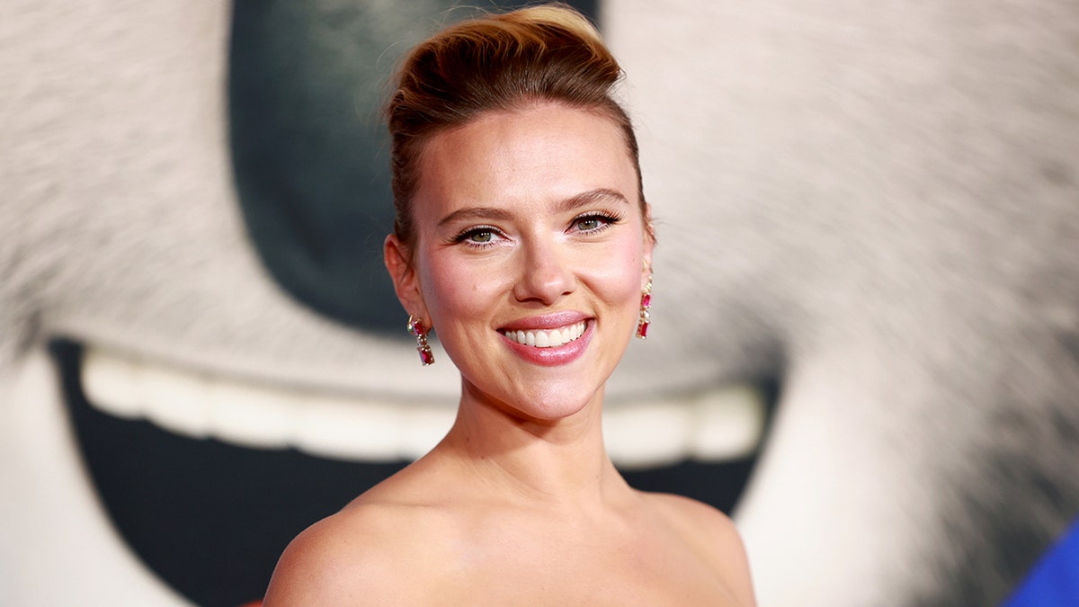 Scarlett Johansson with a high updo and sparkly pink earrings