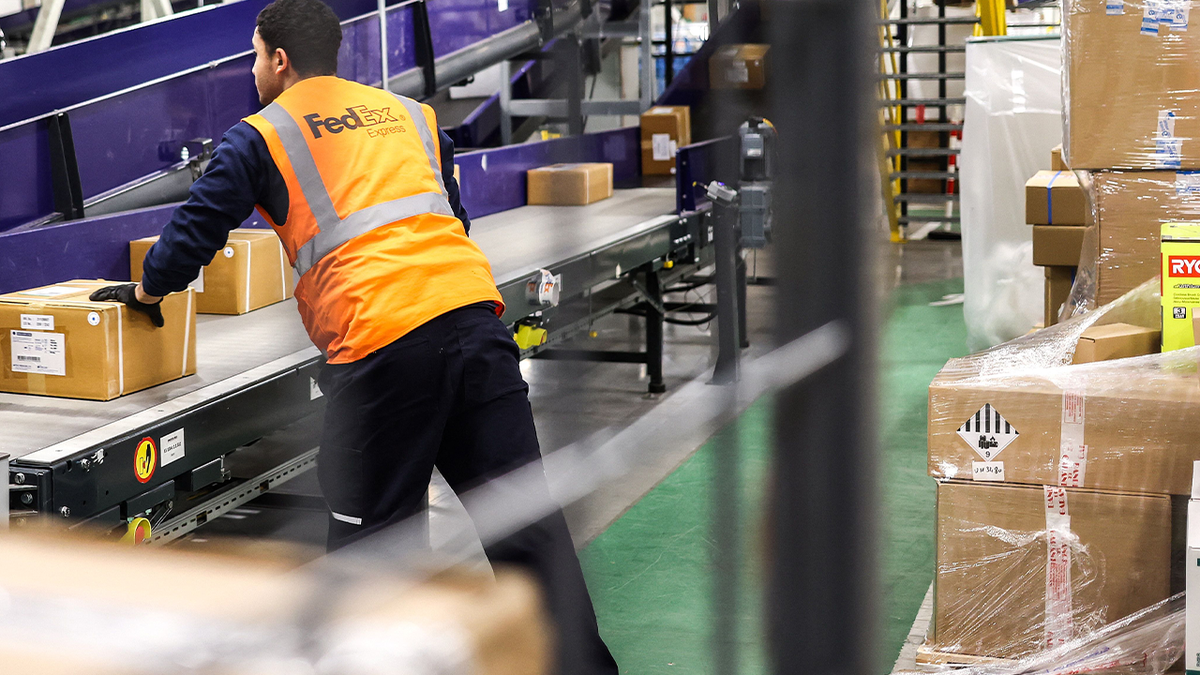 FedEx worker with boxes