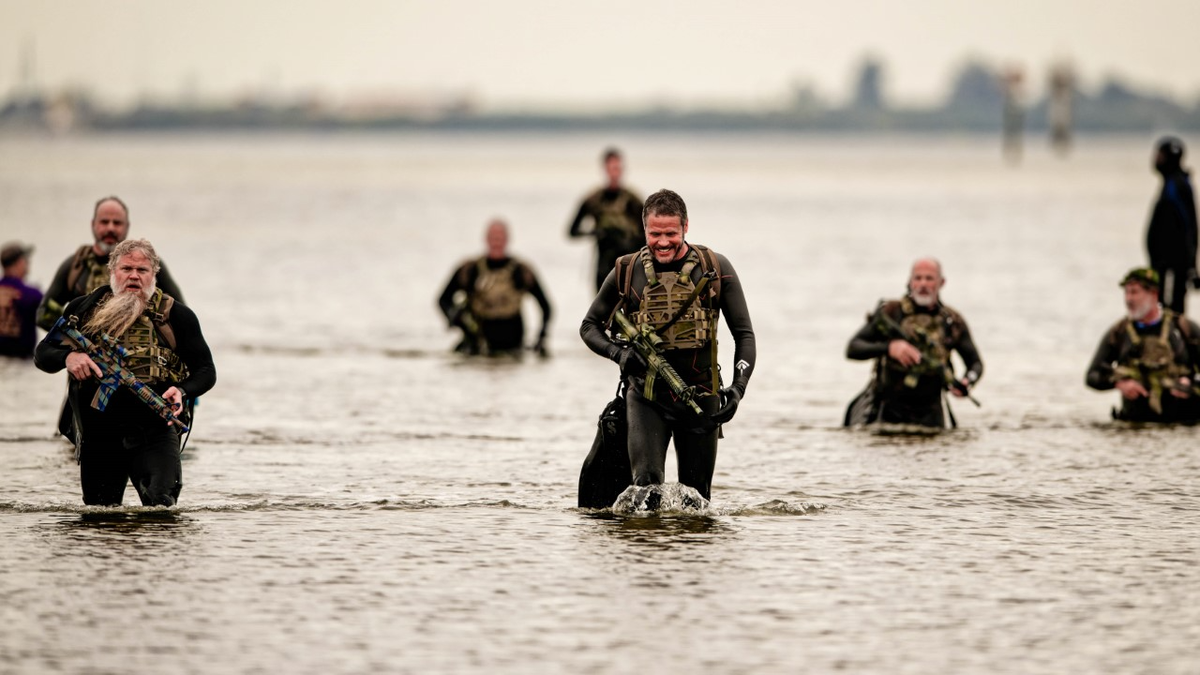 People participate in Frogman Swim