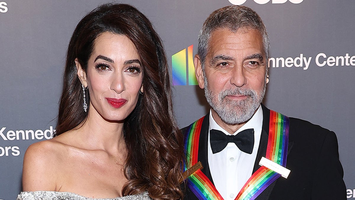 George Clooney and wife Amal Clooney smile on red carpet in Washington D.C.