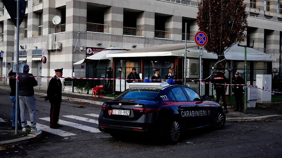 Patrol cars parked out front of an Italian bar following a shooting