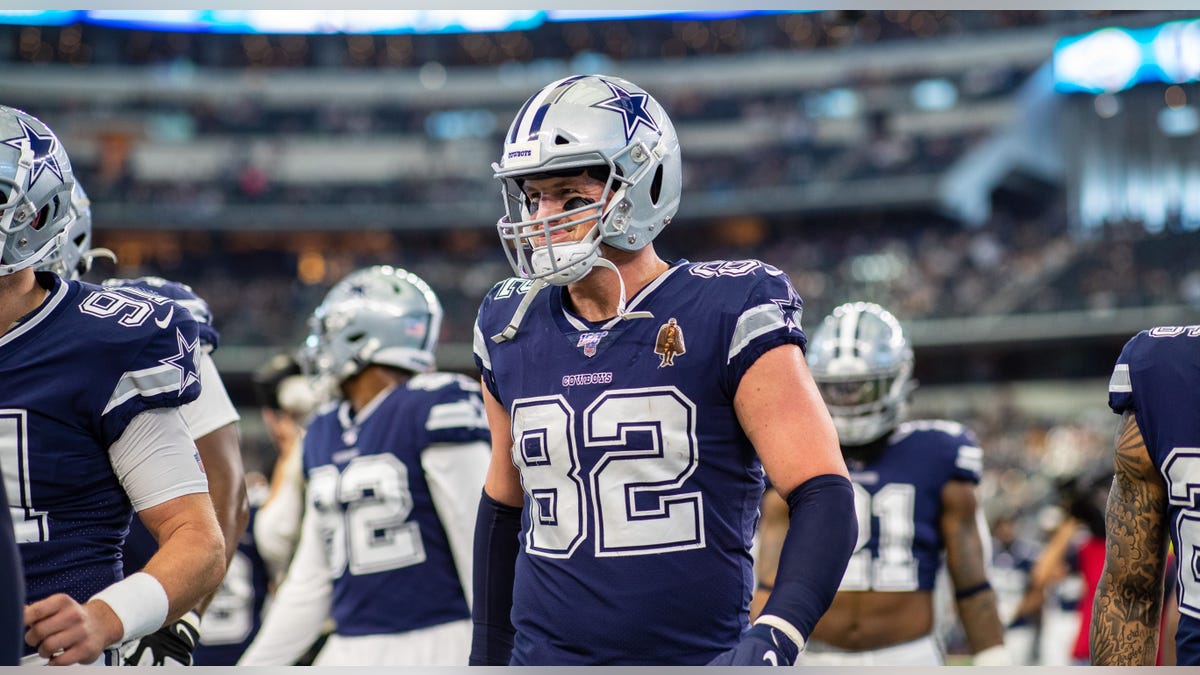 Jason Witten walks with helmet on