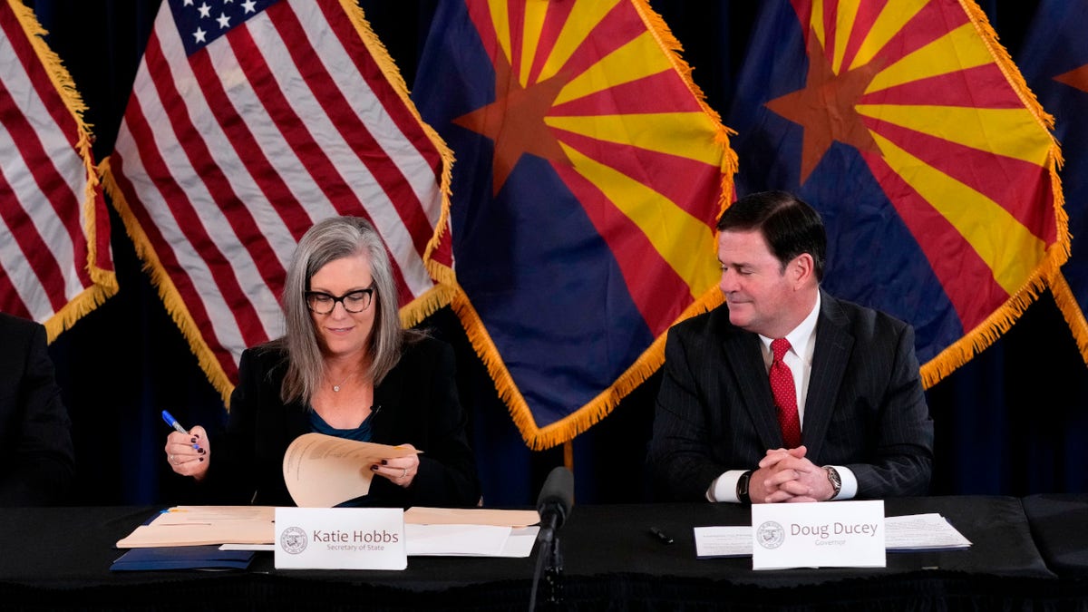 Democrat Katie Hobbs and Republican Gov. Doug Ducey certify the 2022 election results