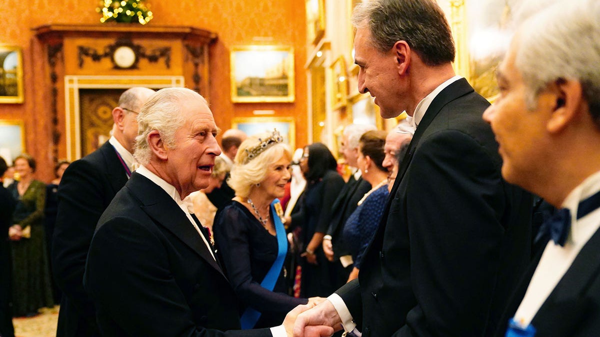 King Charles shaking hands