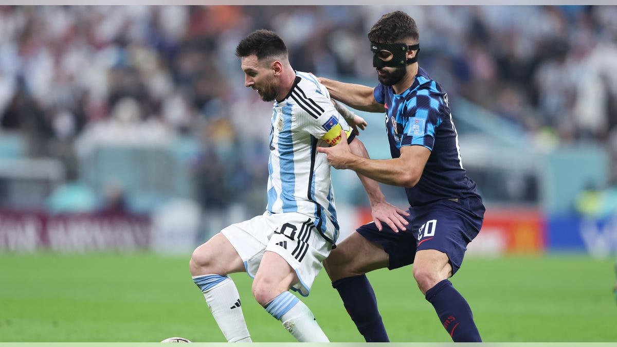 Lionel Messi backs off defender