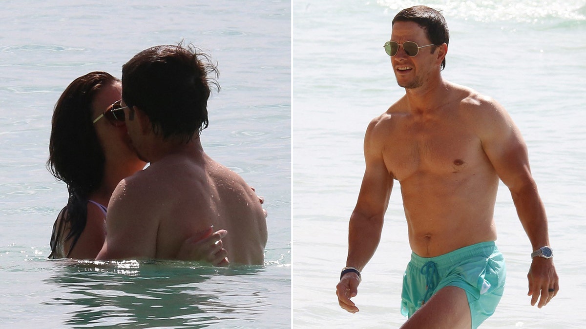 Mark Wahlberg kisses his wife with his back turned to the camera in the water split walks out of the water with sunglasses on and turquoise swim trunks