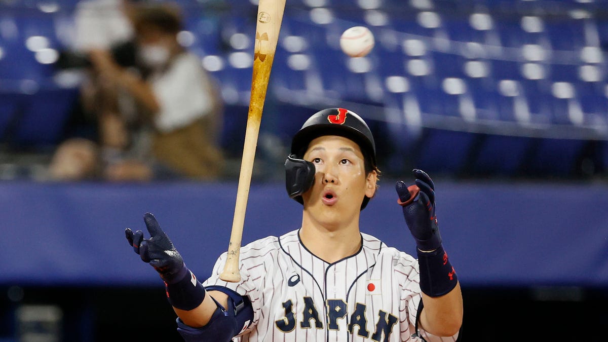 Masataka Yoshida flips bat