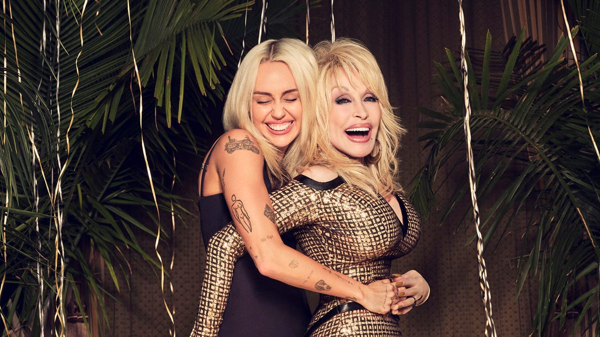 Miley Cyrus and Dolly Parton hugging