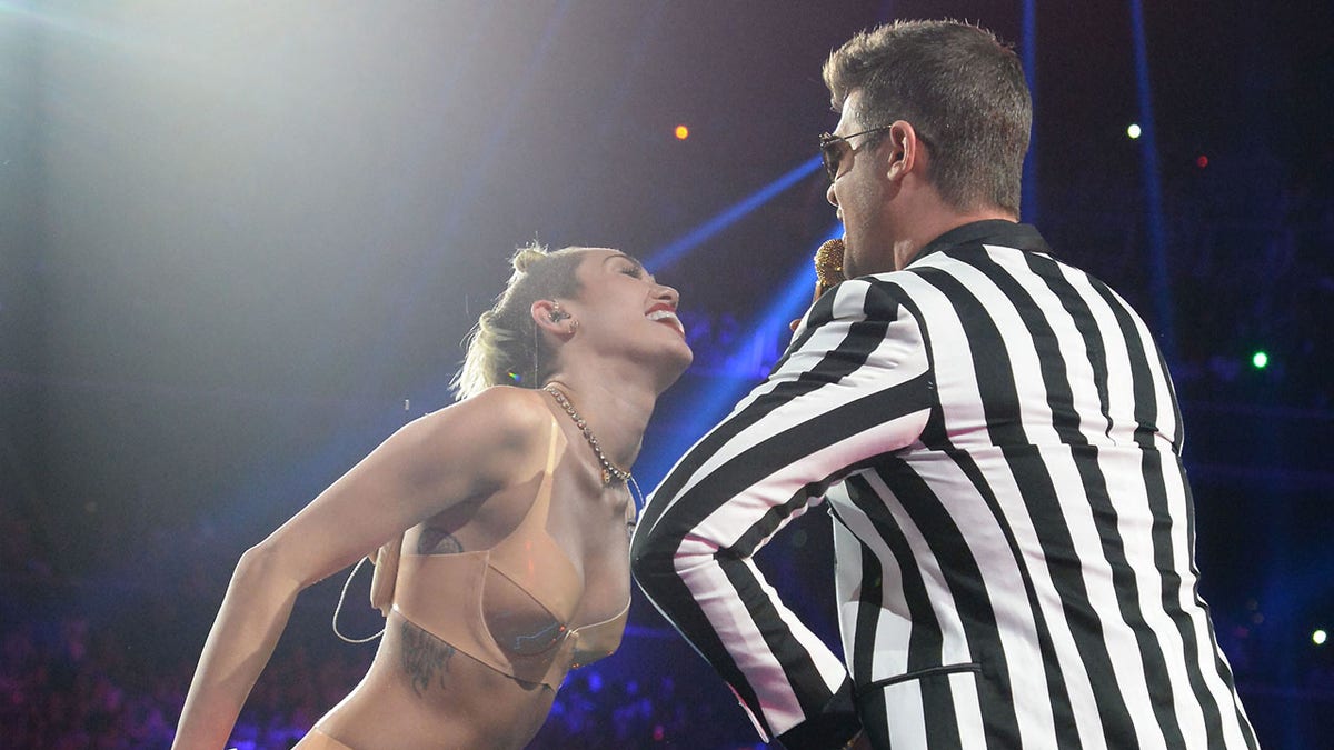 Miley Cyrus dancing with Robin Thicke