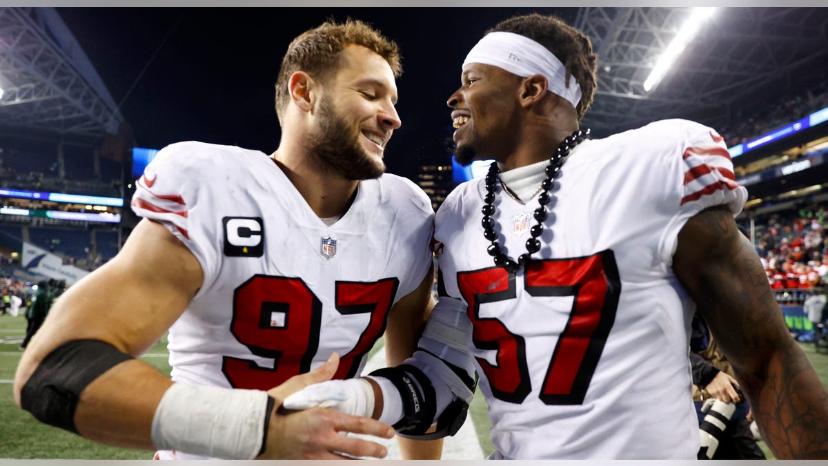 Nick Bosa and Dre Greenlaw smile