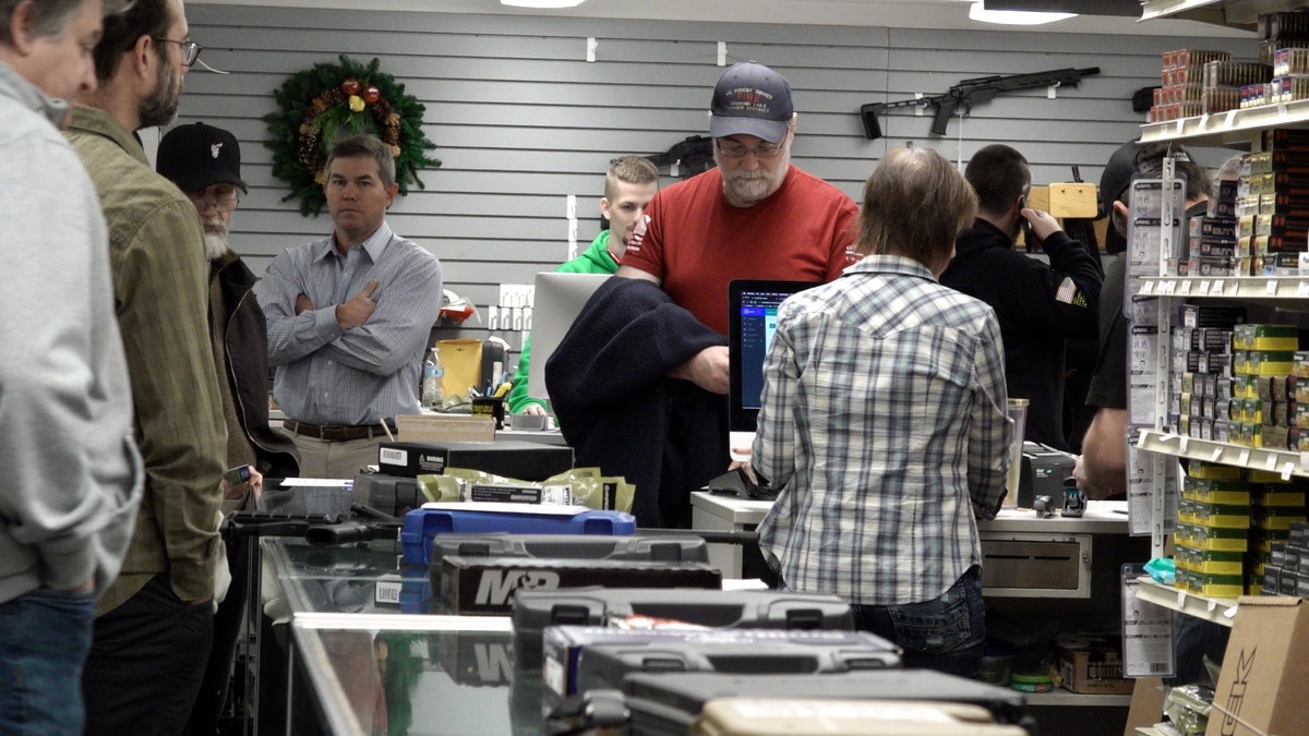 Customers wait in line at Oregon gun store