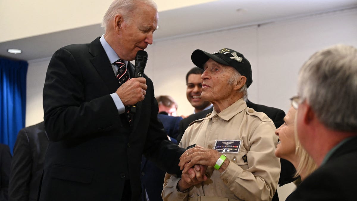President Joe Biden speaks to a WW2 veteran