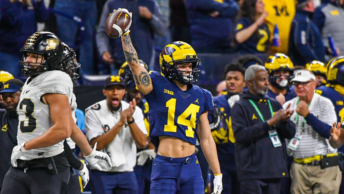 Roman Wilson #14 of the Michigan Wolverines reacts after catching a pass during the first half of the Big Ten football championship game against the Purdue Boilermakers at Lucas Oil Stadium on Dec. 03, 2022 in Indianapolis, Ind.