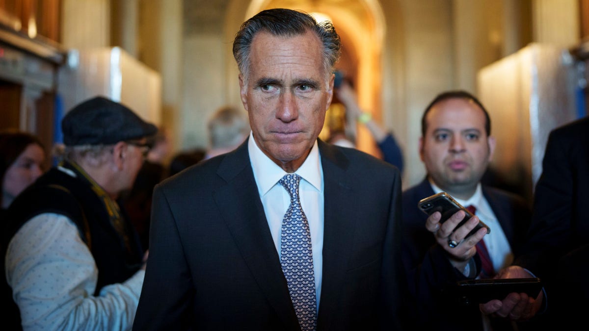 Sen. Mitt Romney leaves the Senate floor after same-sex marriage vote