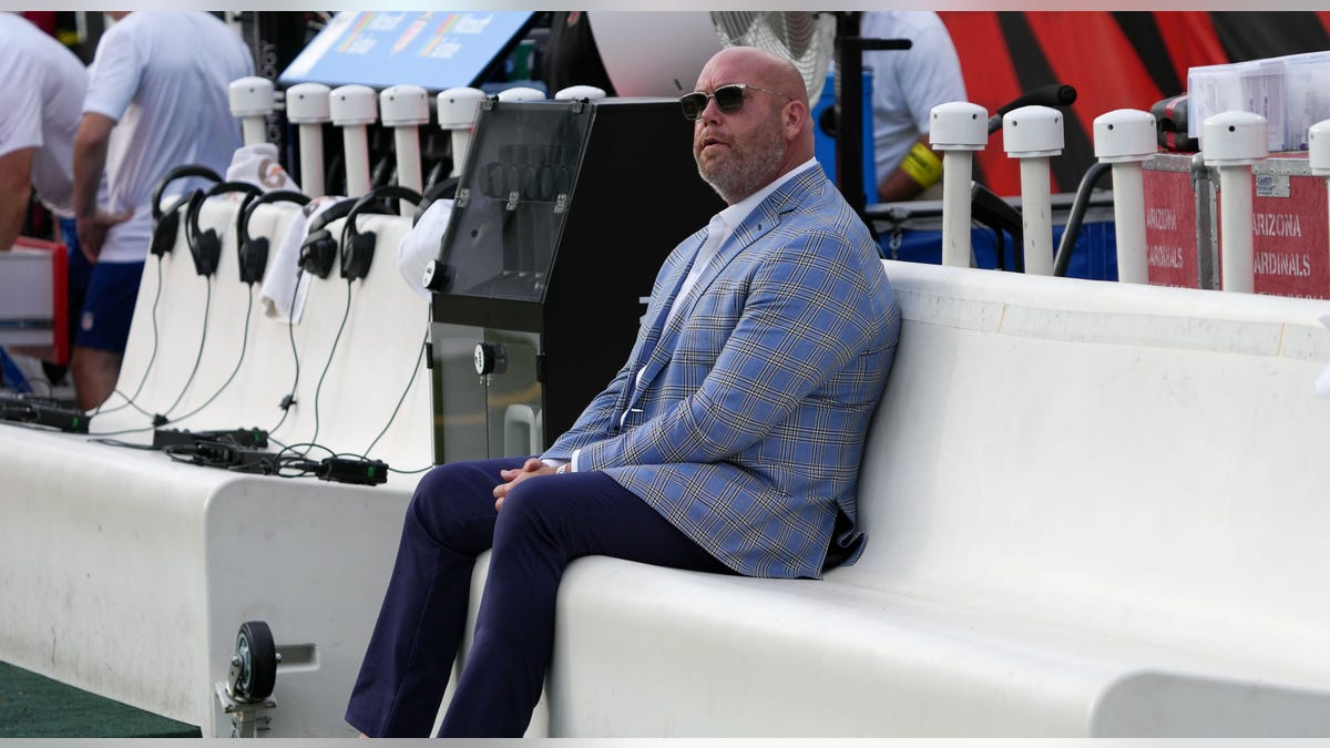 Steve Keim sits and looks on field