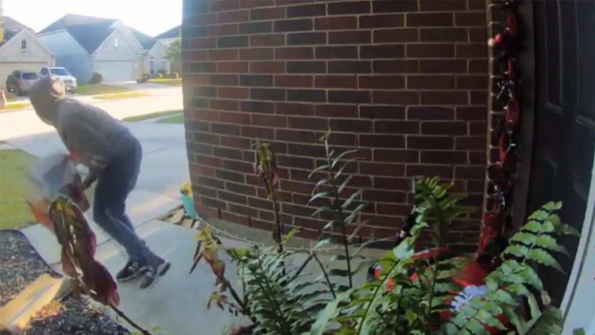 Person stealing Christmas gifts off a person's porch