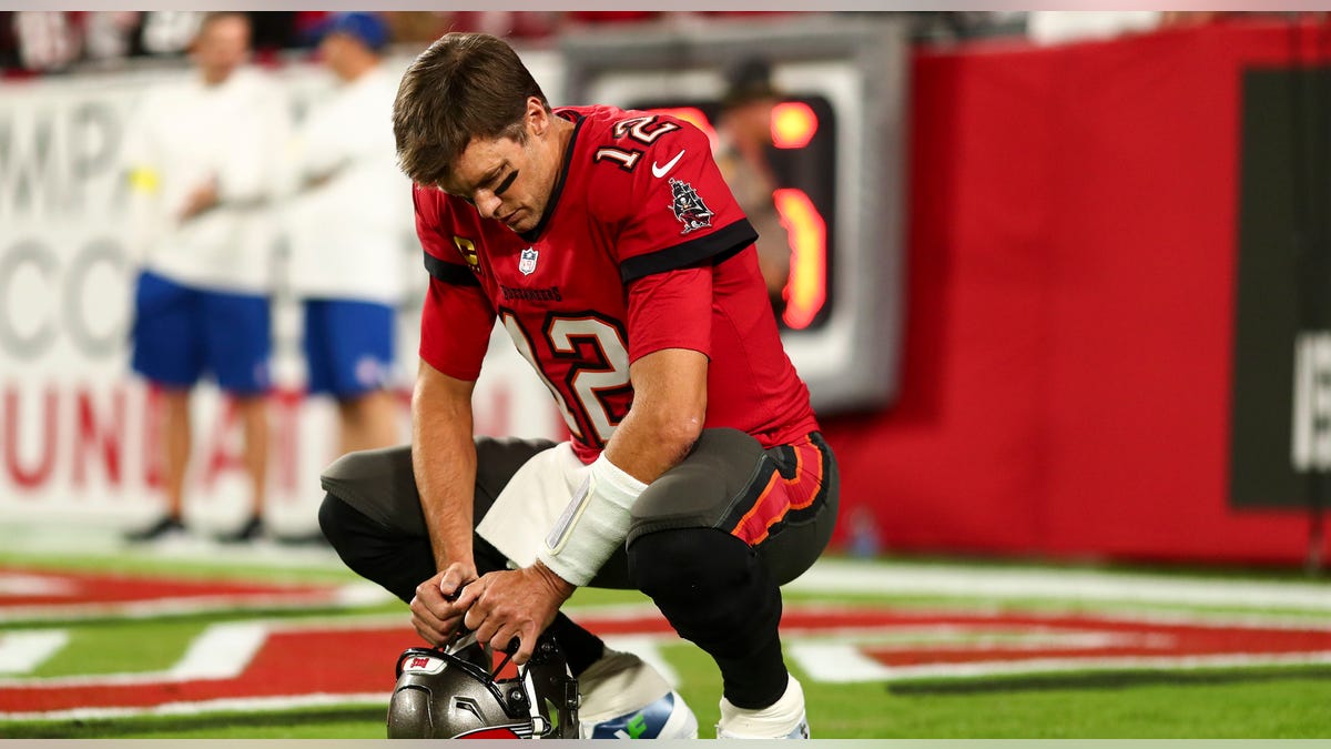 Tom Brady bows head in end zone