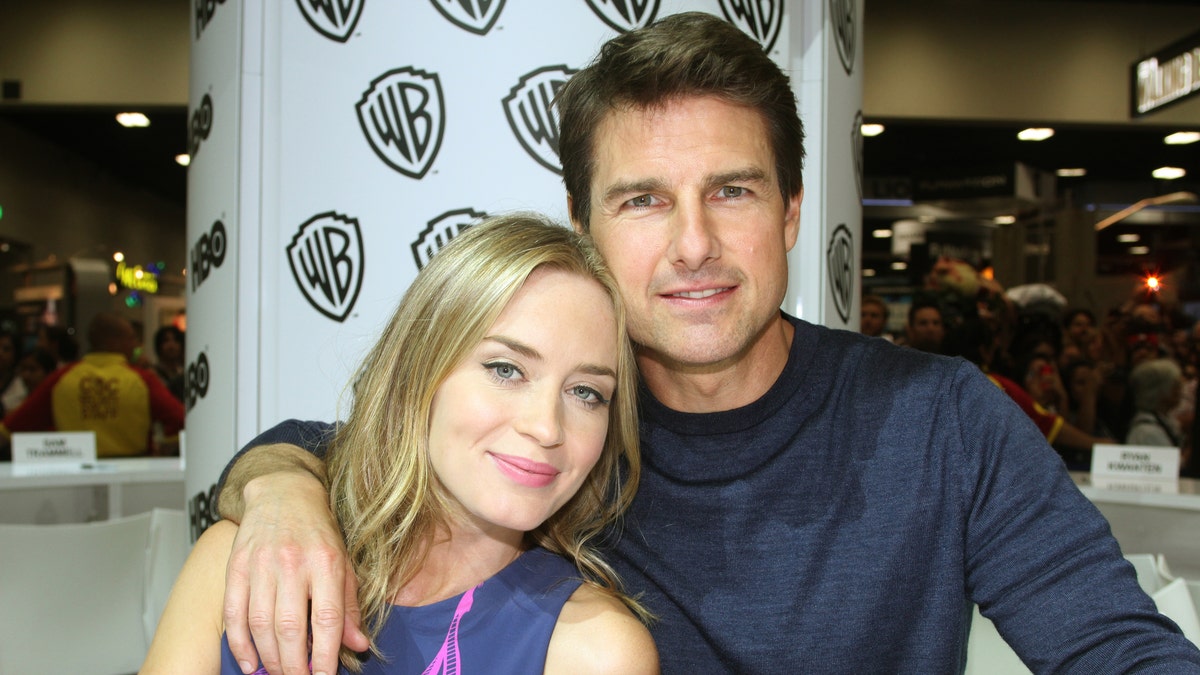 Emily Blunt and Tom Cruise pose for pictures at Comic-Con in San Diego