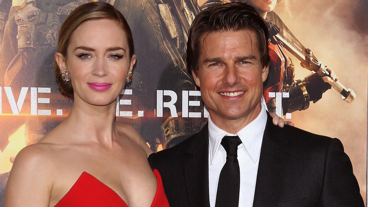 Emily Blunt stands next to Tom Cruise at red carpet premiere