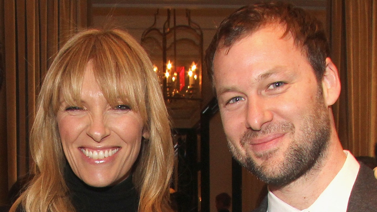 Toni Collette and Dave Galafassi smile at cocktail party