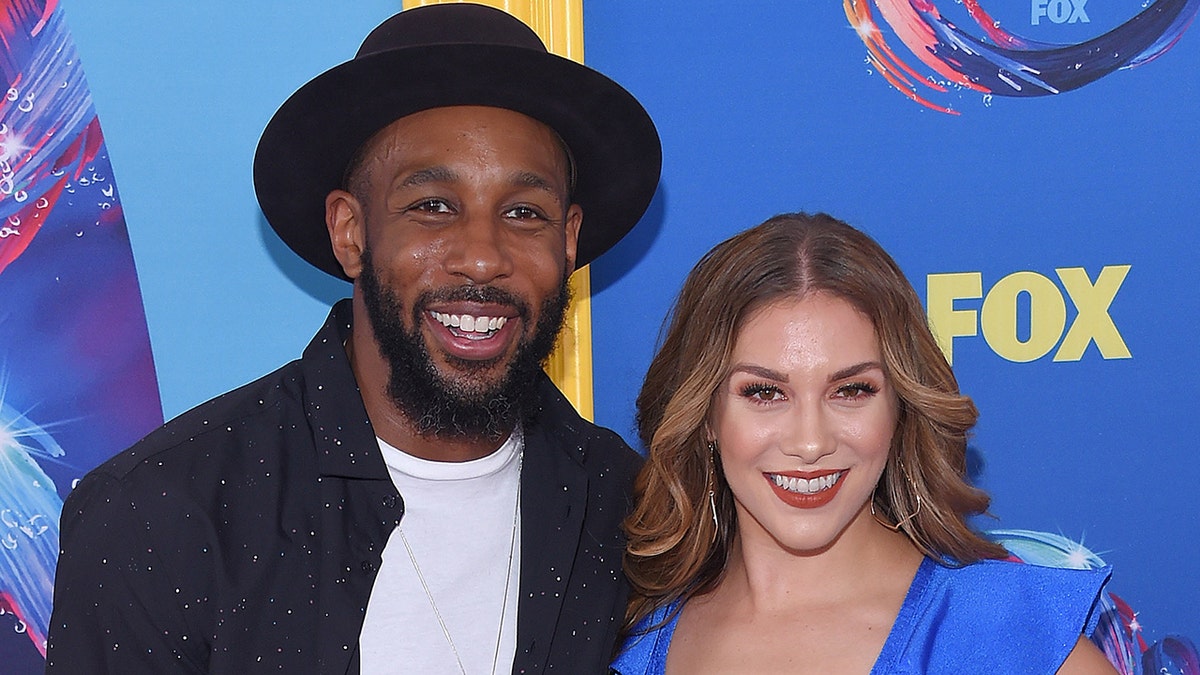 tWitch posed and Allison Holker pose on red carpet