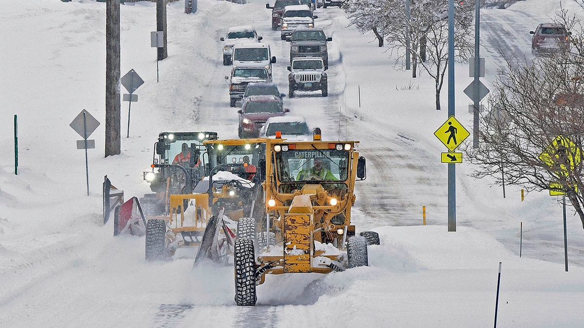 snow plows on snow-covered road