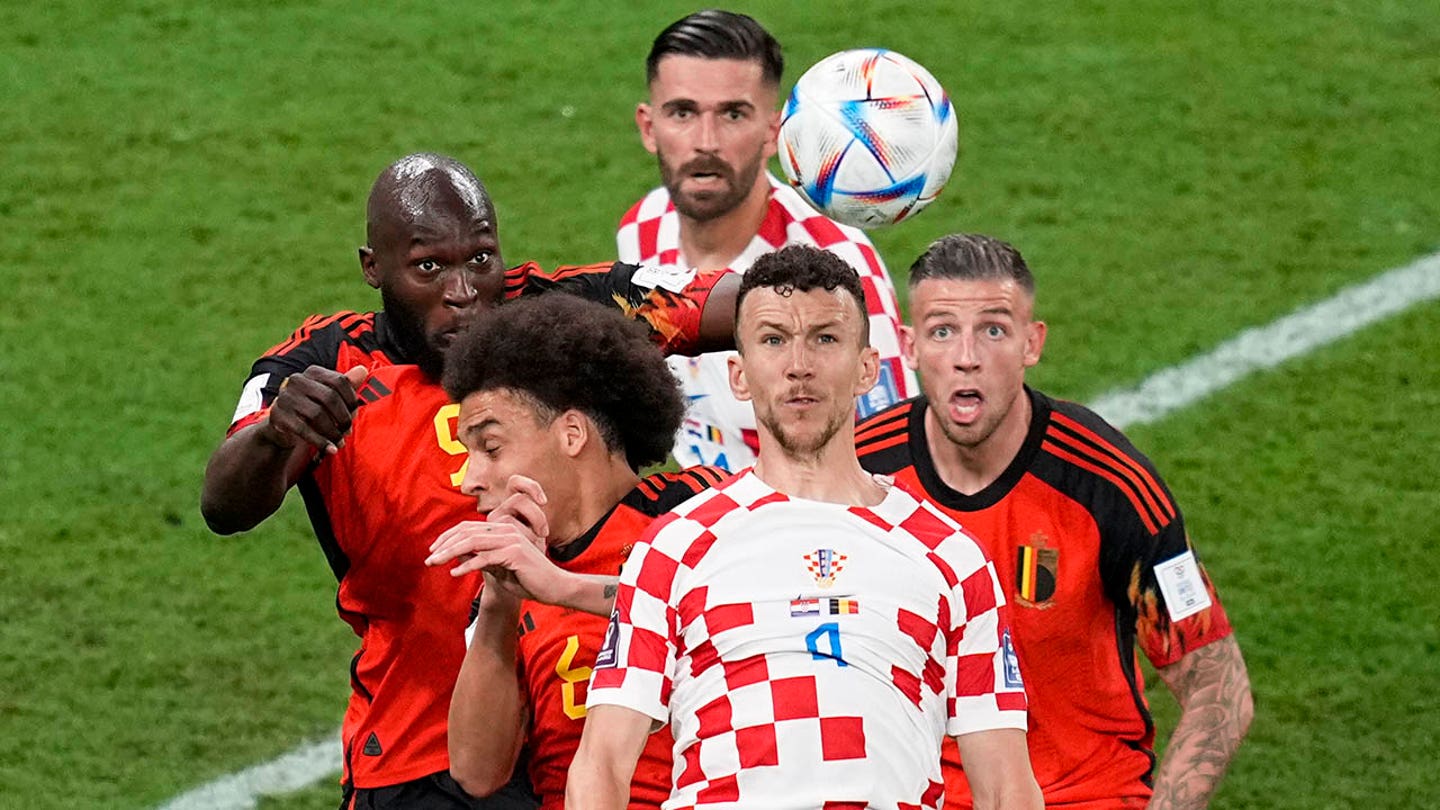 Ivan Perisic of Croatia goes up for the ball against players of Belgium during the World Cup group F match on Thursday, December 1, 2022, at the Ahmad Bin Ali Stadium in Al Rayyan, Qatar. (AP Photo/Ebrahim Noroozi)