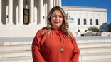 303 Creative owner Lorie Smith stands in front of the Supreme Court.