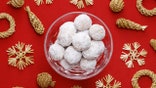 christmas snowball cookies on red table