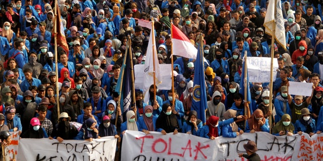 University students march to a local parliament building during a protest in Makassar, South Sulawesi province, Indonesia, on Sept. 27, 2019.