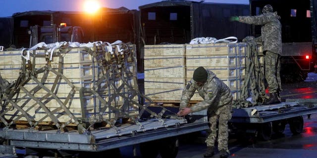 FILE PHOTO: Ukrainian servicemen unload a shipment of military aid delivered as part of US security assistance to Ukraine at Boryspil International Airport near Kyiv, Ukraine.