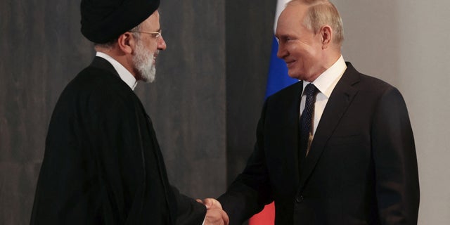 Russian President Vladimir Putin shakes hands with Iranian President Ebrahim Raisi during a meeting on the sidelines of the Shanghai Cooperation Organization (SCO) summit in Samarkand, Uzbekistan September 15, 2022.