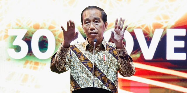 Indonesian President Joko Widodo gestures as he delivers his remarks during the annual meeting of Indonesia's central bank with its financial stakeholders in Jakarta, Indonesia, November 30, 2022. 