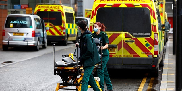 UK warns residents to not get 'blind drunk' throughout 24-hour ambulance strike 2 Staff members of the ambulance service move a stretcher away from an ambulance near The Royal London Hospital in London, Britain, December 19, 2022. (REUTERS/Peter Nicholls)