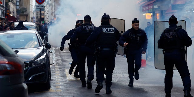 Clashes with French police during a demonstration near the Rue d'Enghien after gunshots were fired killing and injuring several people in a central district of Paris Dec. 23, 2022.  