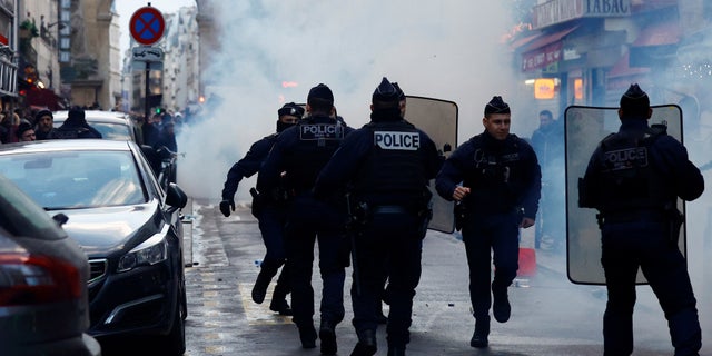 Clashes with French police during a demonstration near the Rue d'Enghien after gunshots were fired killing and injuring several people in a central district of Paris Dec. 23, 2022.  