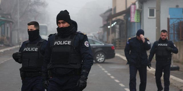 Kosovo police officers patrol at a roadblock near the northern part of the ethnically-divided town of Mitrovica, Kosovo, Dec. 27, 2022.