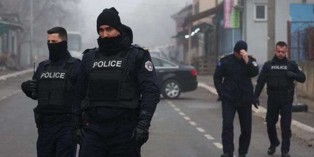 Kosovo police officers patrol at a roadblock near the northern part of the ethnically-divided town of Mitrovica, Kosovo, Dec. 27, 2022.