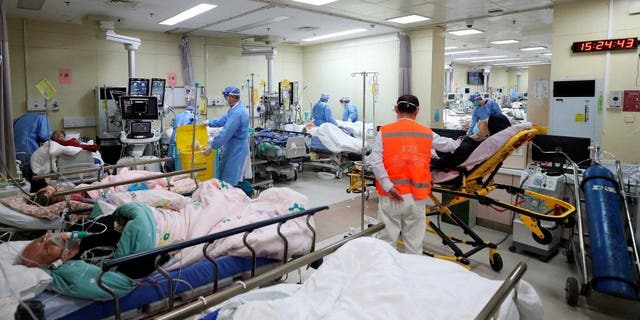 Medical workers attend to patients at the intensive care unit of the emergency department at Beijing Chaoyang Hospital, amid the COVID-19 outbreak.
