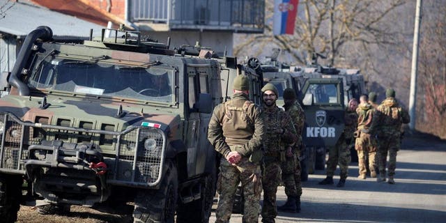 Members of the Italian Armed Forces, part of the NATO peacekeepers mission in Kosovo, stand guard in Rudare, near the northern part of the ethnically-divided town of Mitrovica, Kosovo, Dec. 27, 2022. 