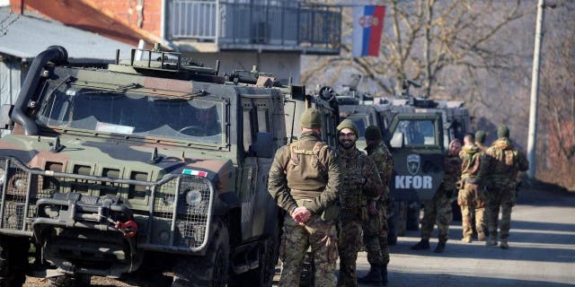 Members of the Italian Armed Forces, part of the NATO peacekeepers mission in Kosovo, stand guard in Rudare, near the northern part of the ethnically-divided town of Mitrovica, Kosovo, Dec. 27, 2022. 