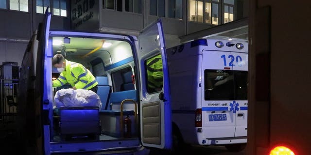 A worker cleans up inside an ambulance outside an emergency department of a hospital, amid the COVID-19 outbreak, in Chengdu, Sichuan province, China, Dec. 27, 2022. 