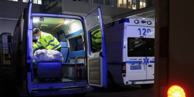 A worker cleans up inside an ambulance outside an emergency department of a hospital, amid the COVID-19 outbreak, in Chengdu, Sichuan province, China, Dec. 27, 2022.