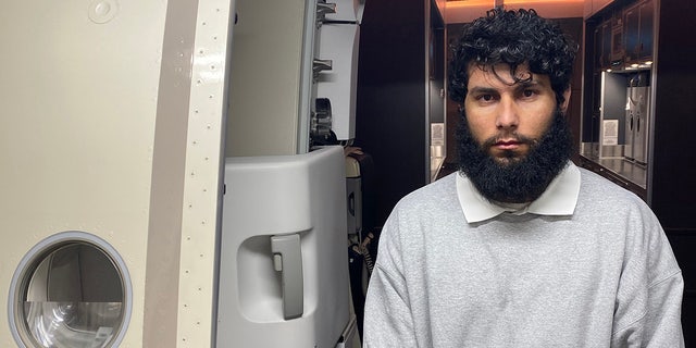 Afghani national Tariq Intezar appears plane side as he is removed from the United States by ICE.