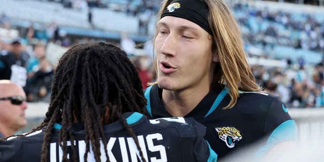 Rayshawn Jenkins #2 of the Jacksonville Jaguars hugs Trevor Lawrence #16 on the field after the game against the Dallas Cowboys at TIAA Bank Field on December 18, 2022 in Jacksonville, Florida.