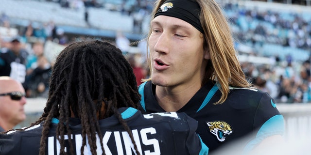 Jacksonville Jaguars' Rayshawn Jenkins, left, hugs Trevor Lawrence on the field after a game against the Dallas Cowboys at TIAA Bank Field on December 18, 2022 in Jacksonville, Florida.