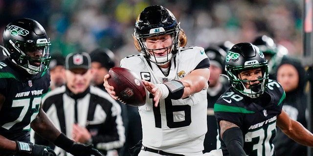 Jacksonville Jaguars quarterback Trevor Lawrence, #16, tries to get the ball across the goal line as he steps out of bounds against the New York Jets during the second quarter of an NFL football game, Thursday, Dec. 22, 2022, in East Rutherford, New Jersey.