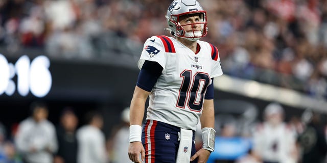 Mac Jones, #10 of the New England Patriots, reacts as he looks on during an NFL football game between the Las Vegas Raiders and the New England Patriots at Allegiant Stadium on Dec. 18, 2022 in Las Vegas.